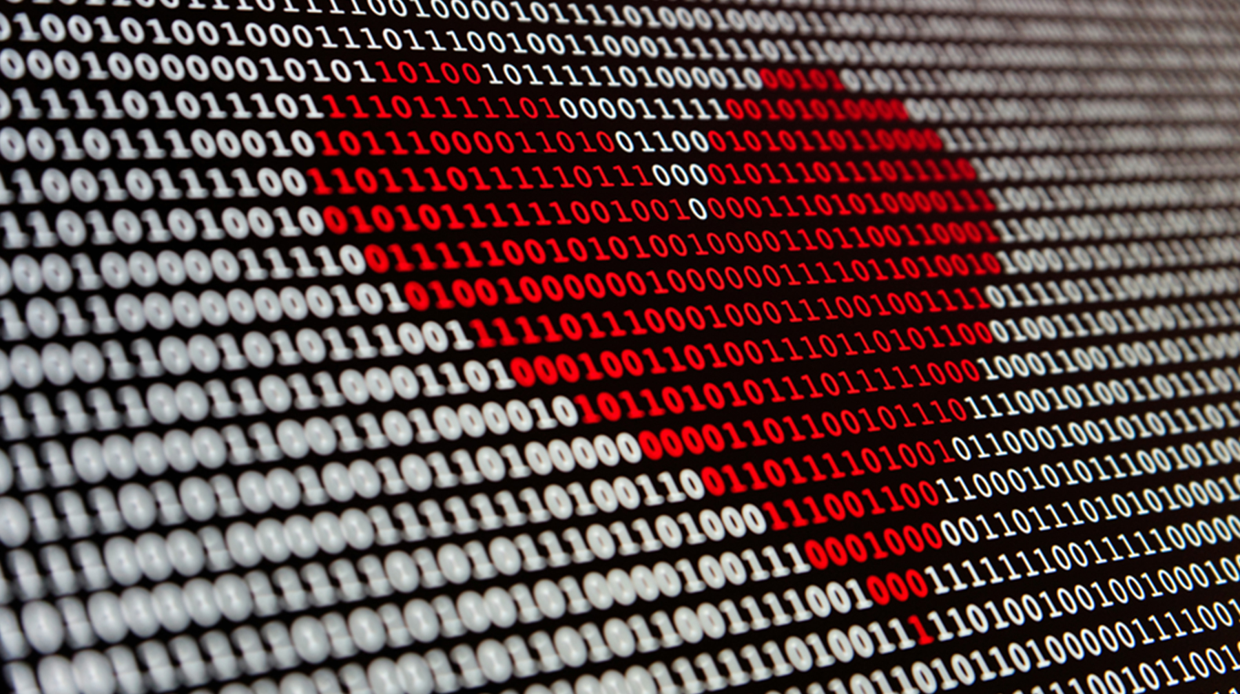 Un cœur rouge formé de 0 et de 1 est affiché sur un écran d’ordinateur, Photo de Alexander Sinn sous la Licence Unsplash